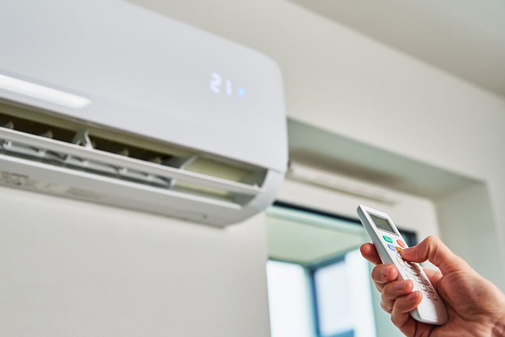 Residential owner adjusting temperature of an indoor Air Conditioner using a remote