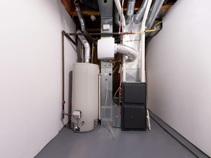 A furnace installed in a spacious utility room of a bustling commercial property with connected Industrial pipes and ducts