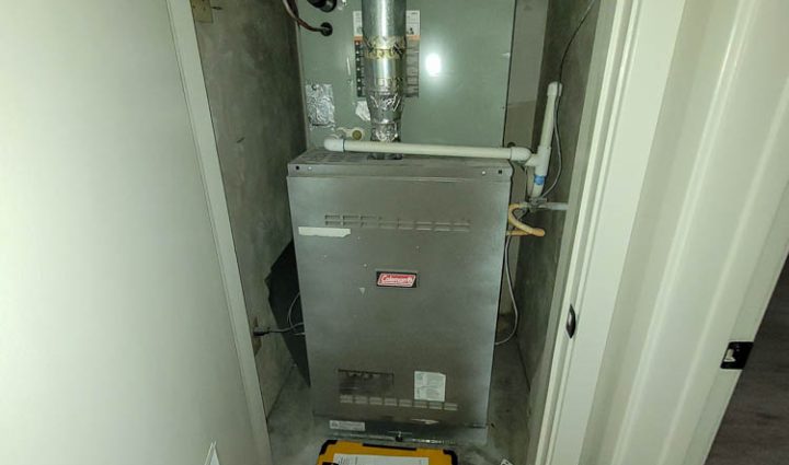 A dependable boiler installed in a compact utility room with a network of pipes and valves connected to it